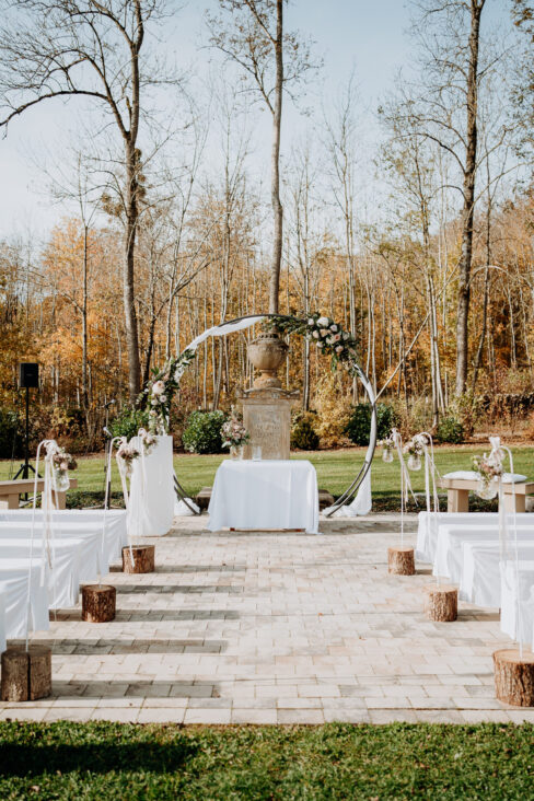 Setting einer freien Trauung mit Traubogen im Mittelpunkt